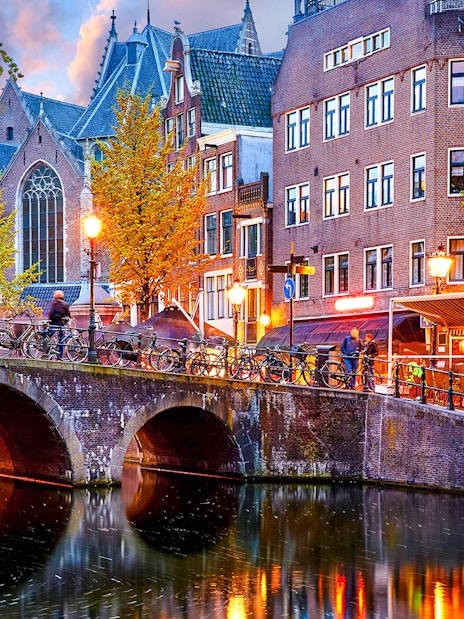 Canal bridge and historic buildings in Amsterdam Red Light District.