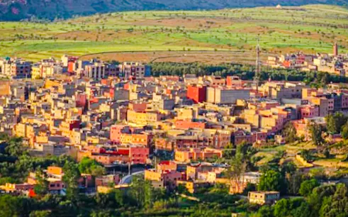 Aerial view of Amizmiz town surrounded by green valleys near Marrakesh.