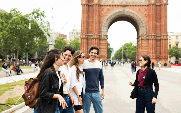 Tourists with guide at Arc de Triomf in Barcelona.