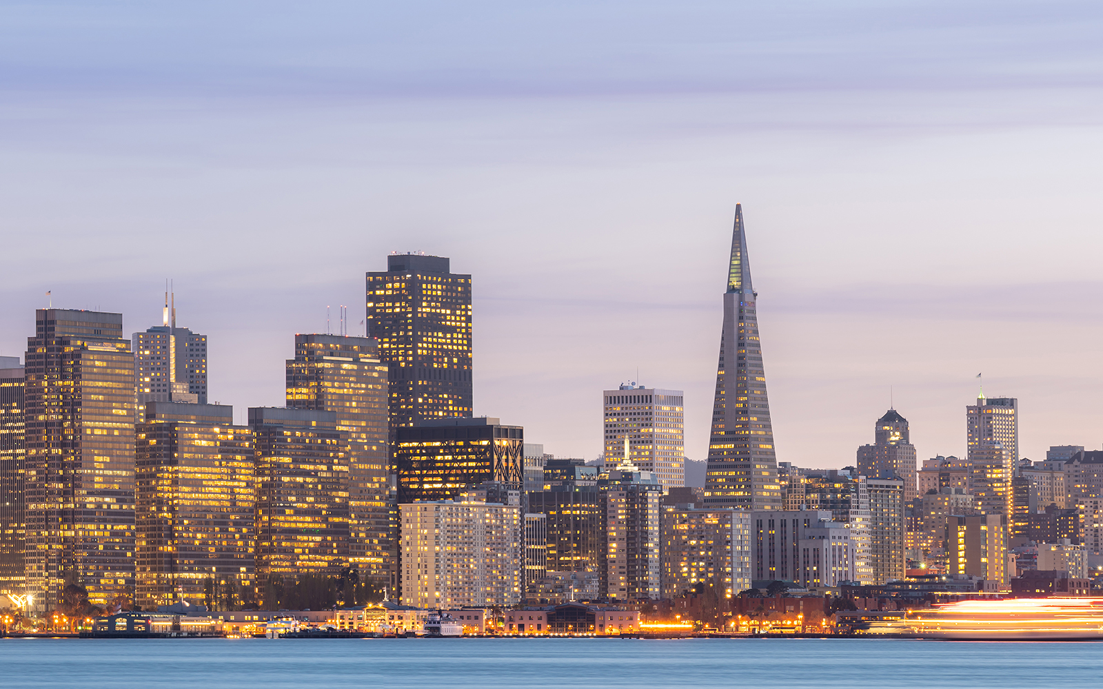 San Francisco skyline with Transamerica Pyramid at sunset during Big Bus tour.