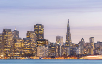 San Francisco skyline with Transamerica Pyramid at sunset during Big Bus tour.