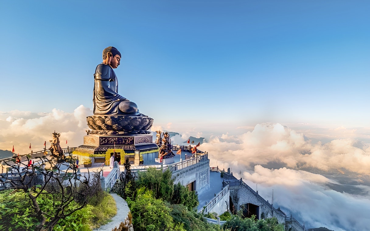 Buddha statue at Sun World Fansipan Legend, Vietnam, surrounded by clouds and mountain views.
