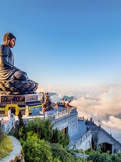 Buddha statue at Sun World Fansipan Legend, Vietnam, surrounded by clouds and mountain views.