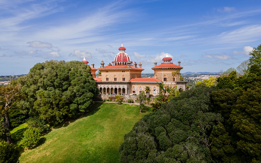 Monserrate Palace in Sintra surrounded by lush gardens and trees.