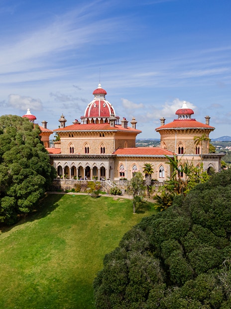Monserrate Palace in Sintra surrounded by lush gardens and trees.