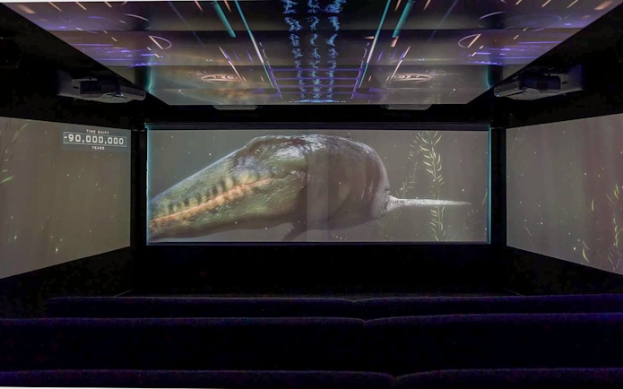 Underwater theatre showing prehistoric marine creature on screen.