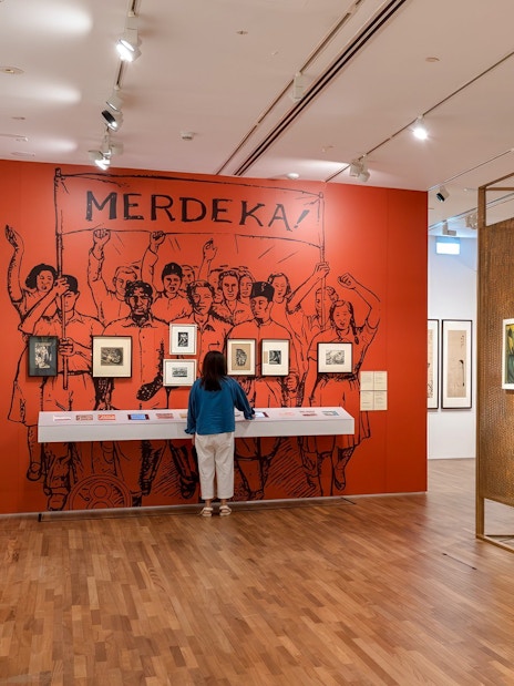 Interior of National Gallery Singapore showcasing modern art exhibits and visitors.