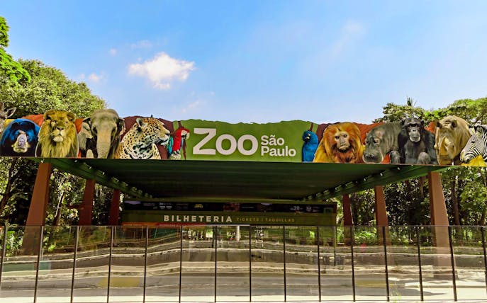 Entrance of São Paulo Zoo with animal images on the sign.