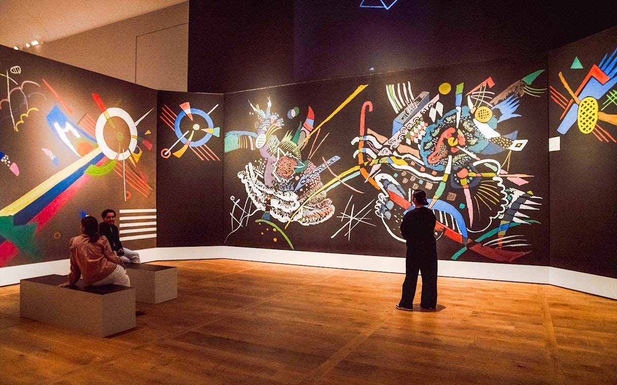 Guests viewing abstract art inside the Hart Museum of Amsterdam.