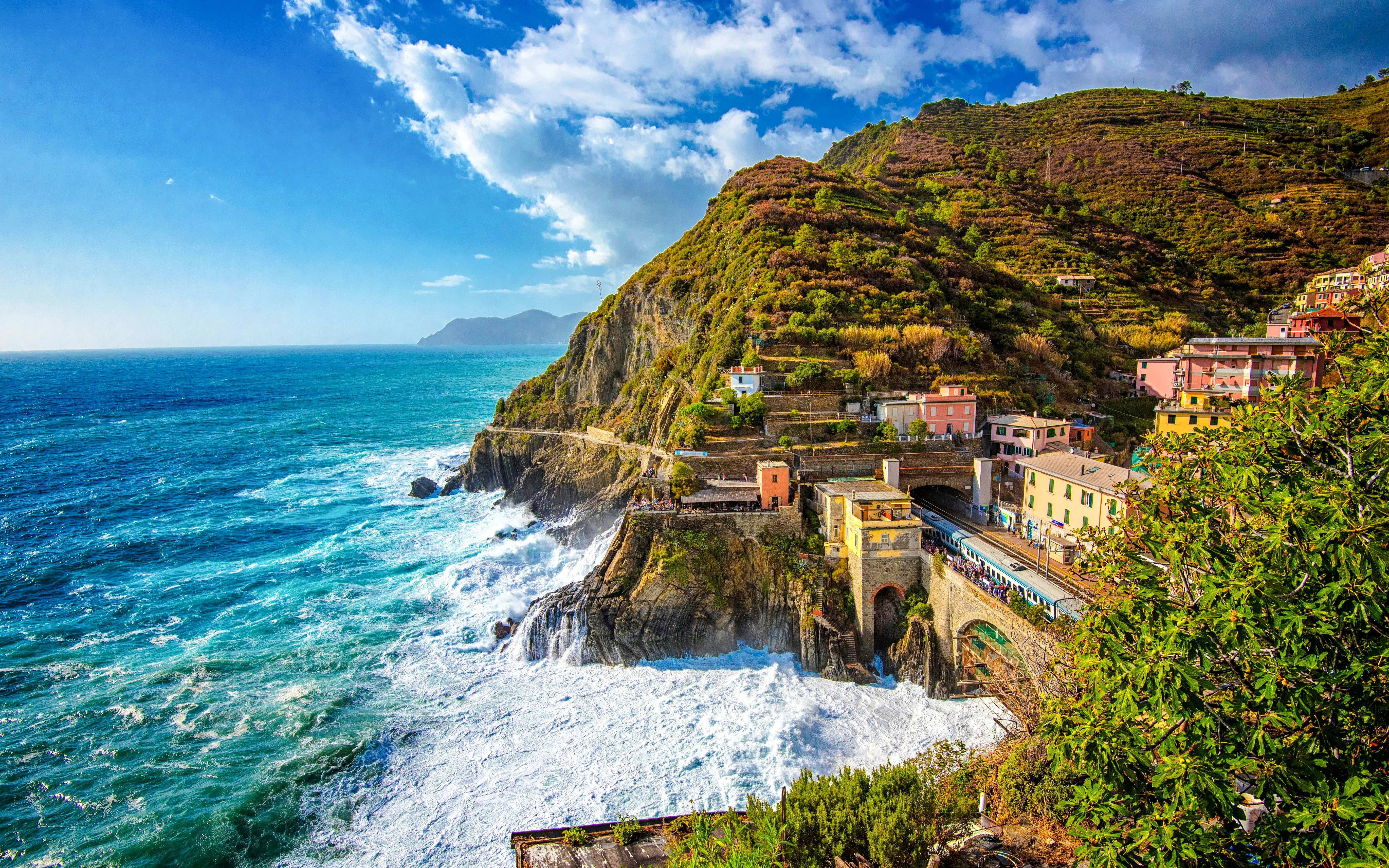 Manarola railway station with coastal cliffs and colorful buildings, Cinque Terre, Italy.