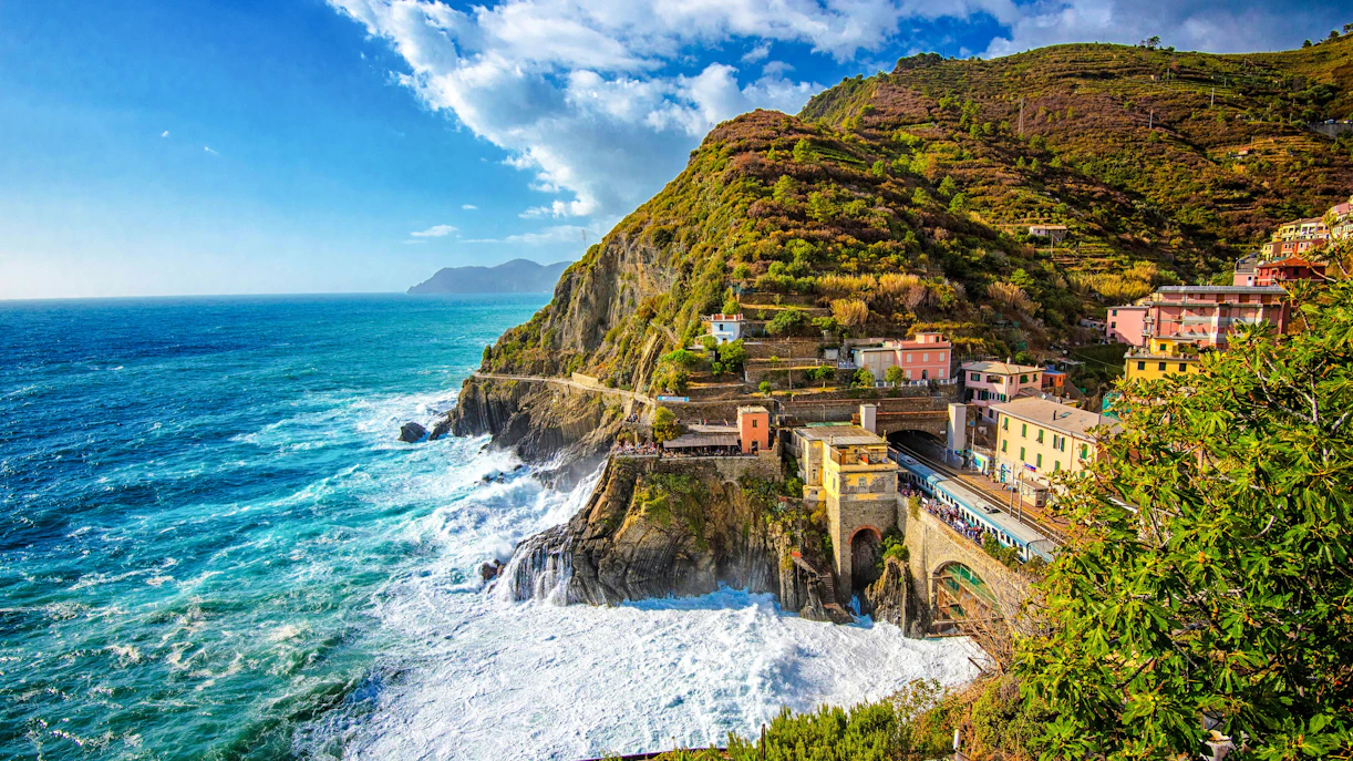 Manarola railway station with coastal cliffs and colorful buildings, Cinque Terre, Italy.