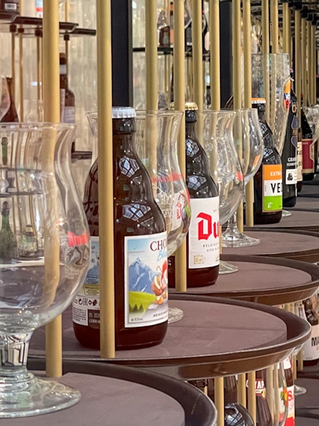 Belgian beer bottles and glasses displayed at Belgian Beer World, Brussels.