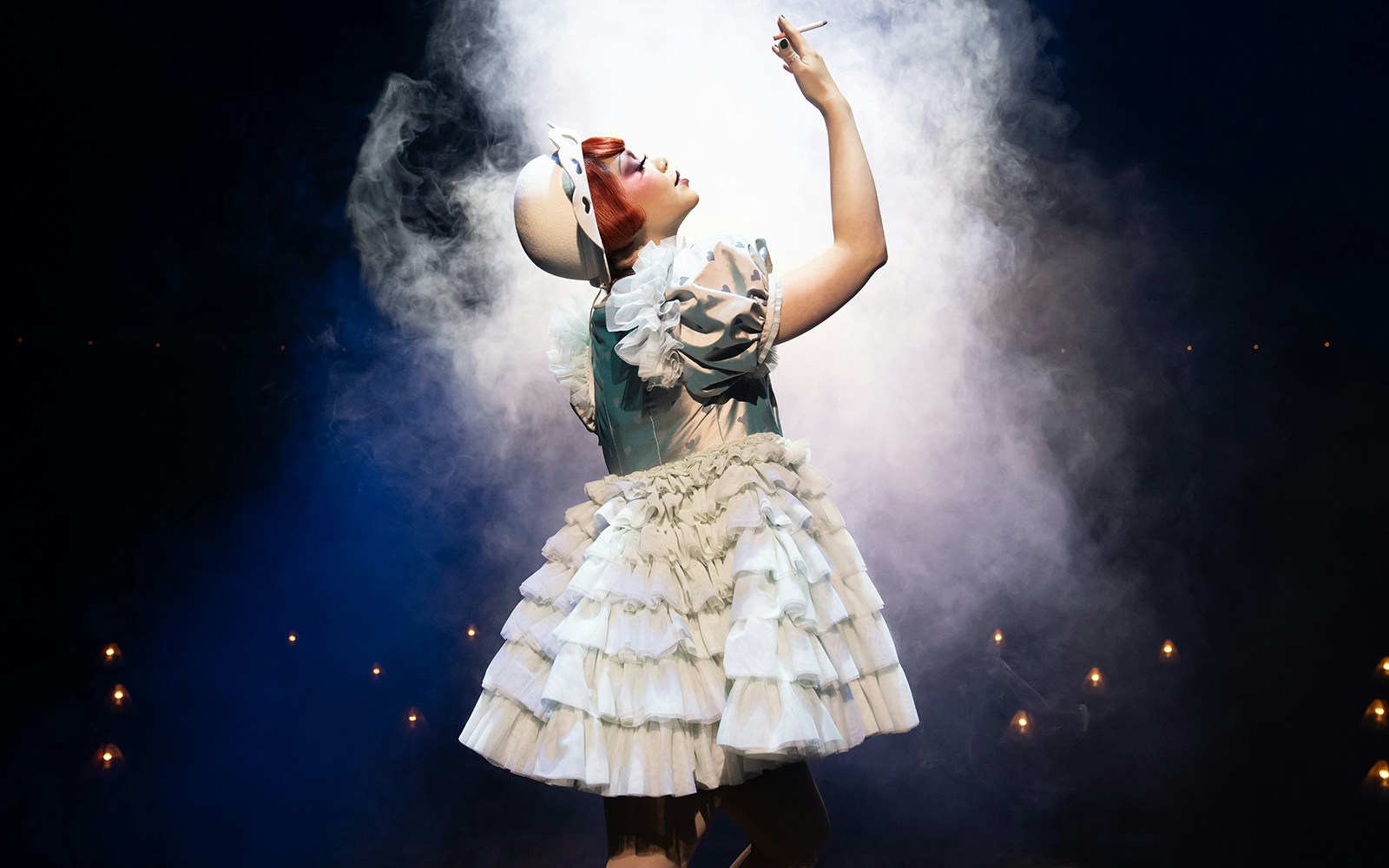 Performer in costume on stage during a cabaret show.
