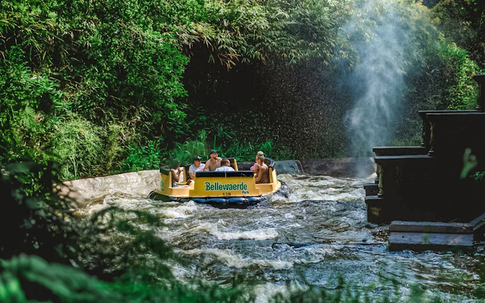 Visitors on a raft at Bengal Rapid River Ride, Bellewaerde Christmas Park, surrounded by festive decorations.
