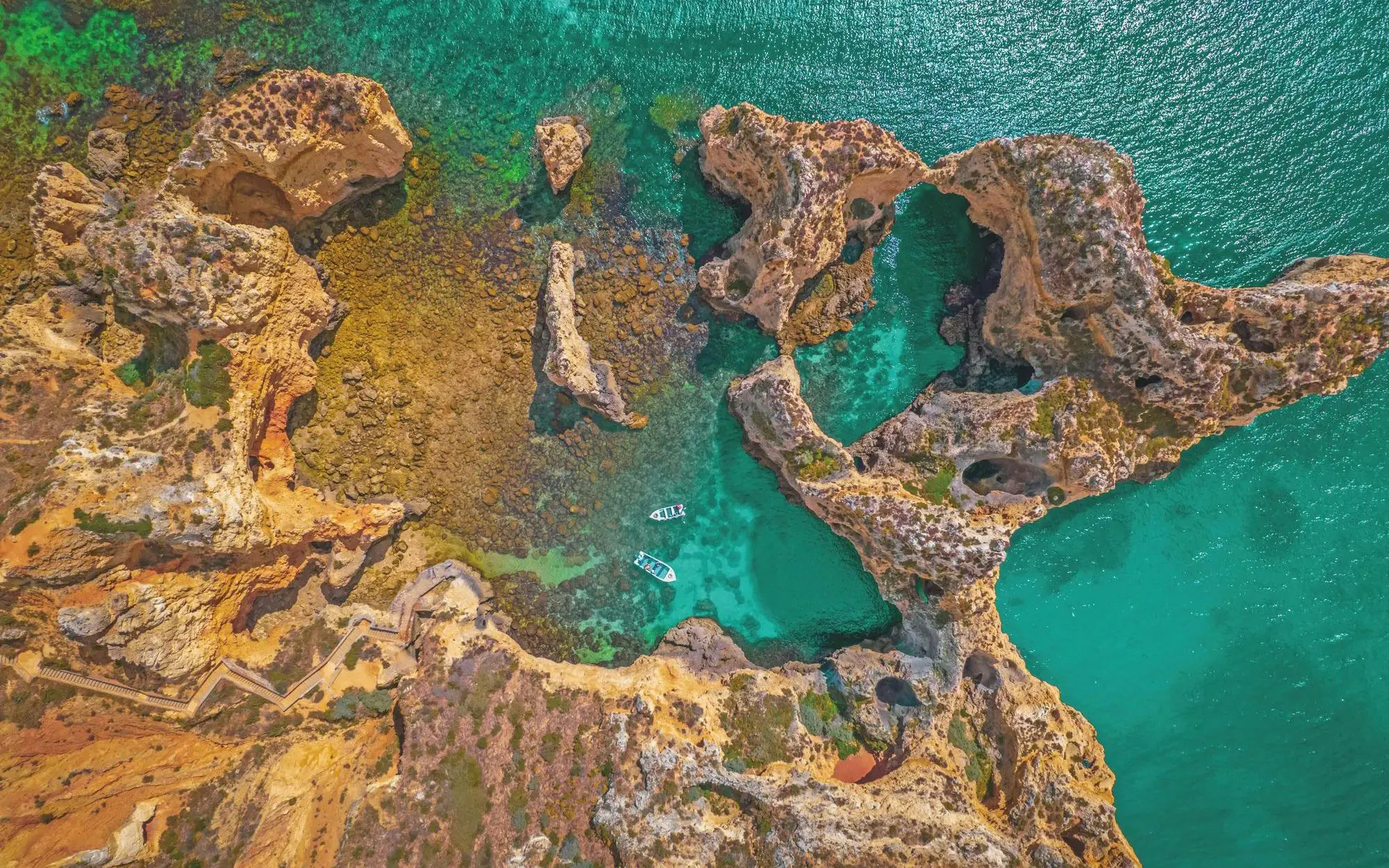 Aerial view of Ponta da Piedade cliffs and turquoise waters, Algarve, Portugal.
