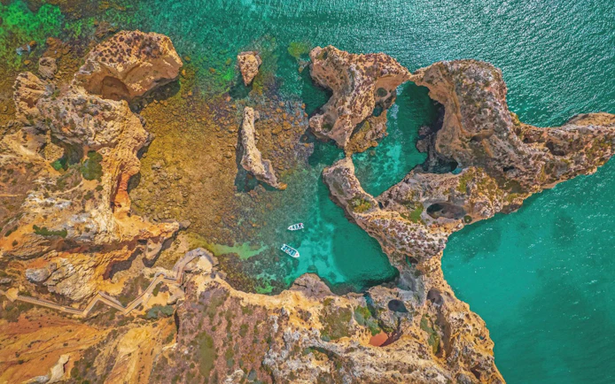 Aerial view of Ponta da Piedade cliffs and turquoise waters, Algarve, Portugal.