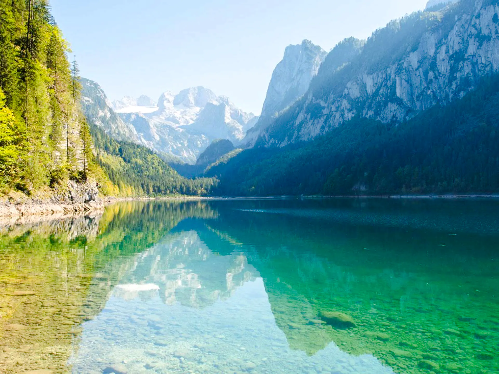 Alpine lake with mountain reflections on the Hallstatt tour from Salzburg.