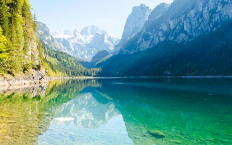 Alpine lake with mountain reflections on the Hallstatt tour from Salzburg.