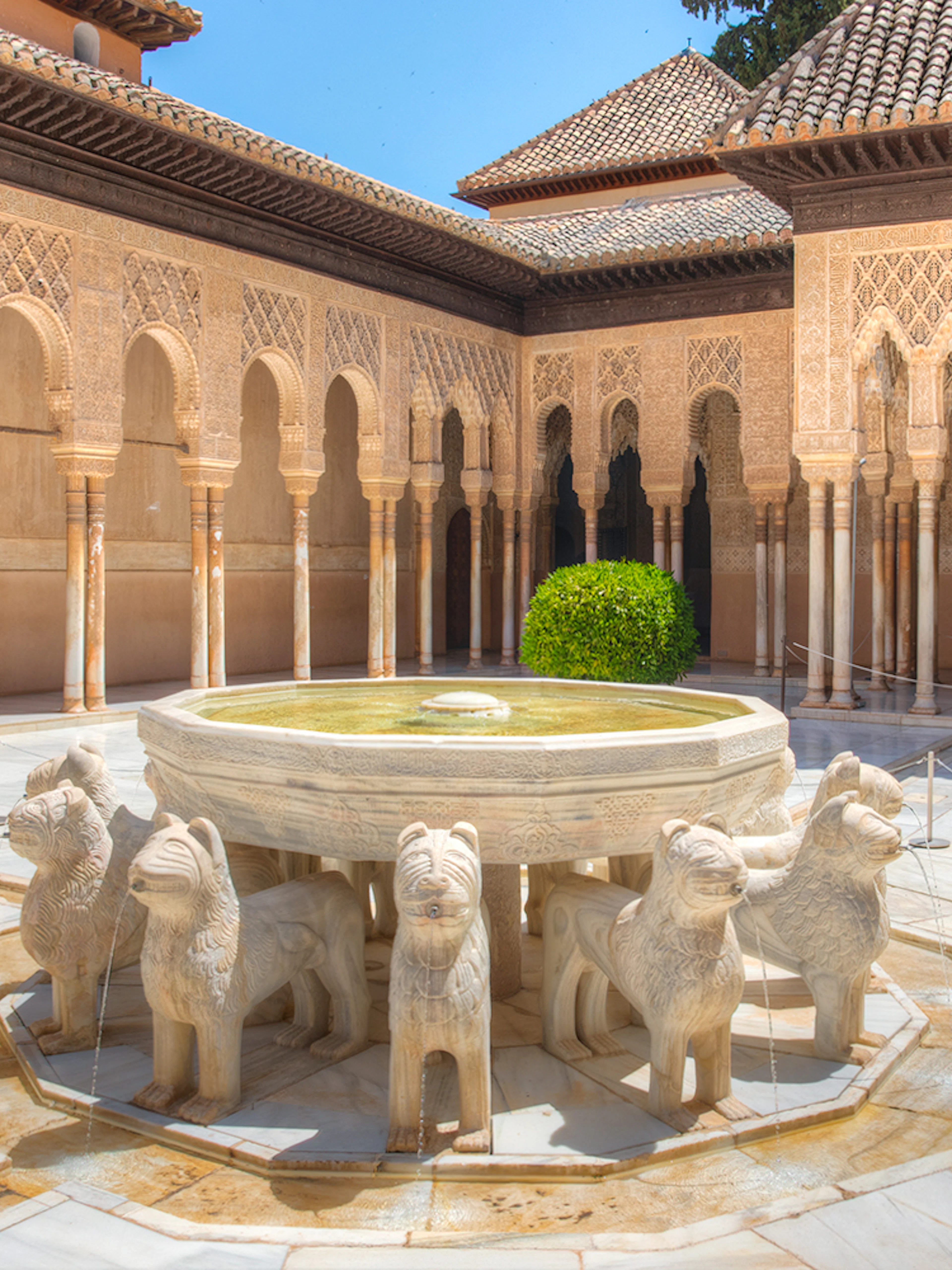 Courtyard of the Lions with ornate arches at Alhambra, Granada.