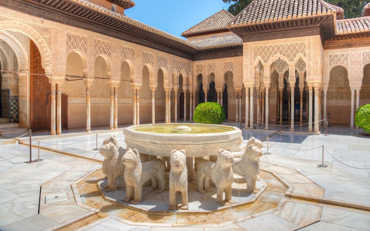 Courtyard of the Lions with ornate arches at Alhambra, Granada.