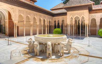 Courtyard of the Lions with ornate arches at Alhambra, Granada.