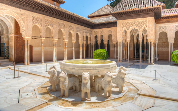 Courtyard of the Lions with ornate arches at Alhambra, Granada.