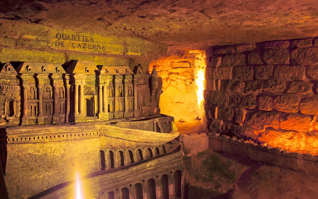 Ancient Roman Catacombs with detailed carvings, part of the Jubilee Silver Pass tour.