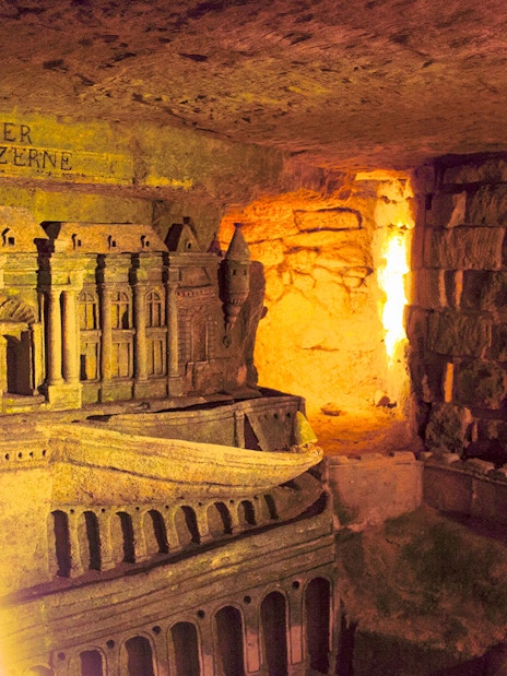 Ancient Roman Catacombs with detailed carvings, part of the Jubilee Silver Pass tour.