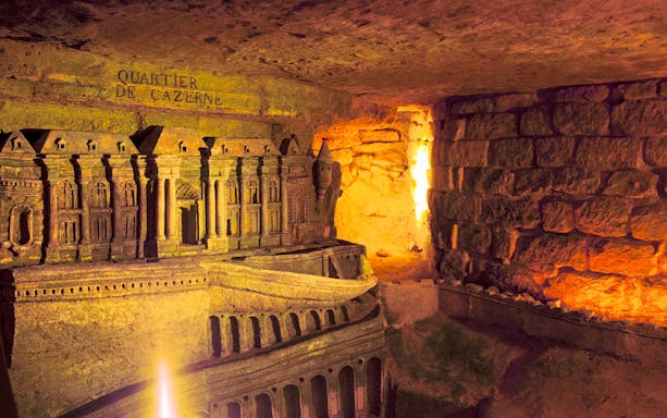 Ancient Roman Catacombs with detailed carvings, part of the Jubilee Silver Pass tour.