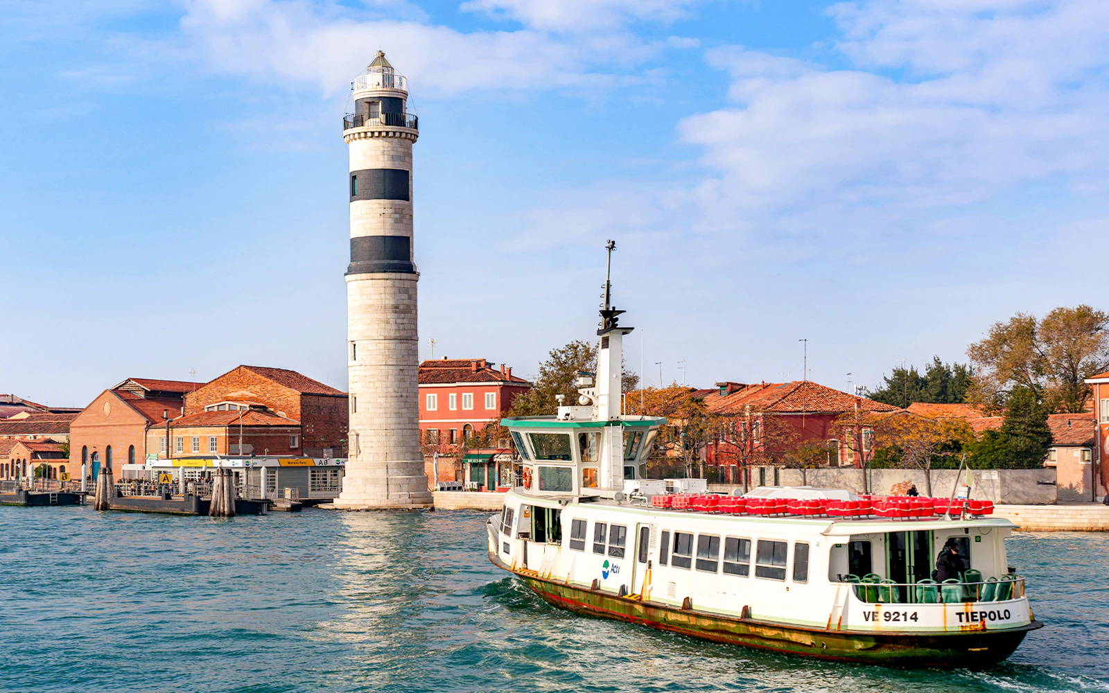 Vaporetto sailing near Murano Island lighthouse, Venice.