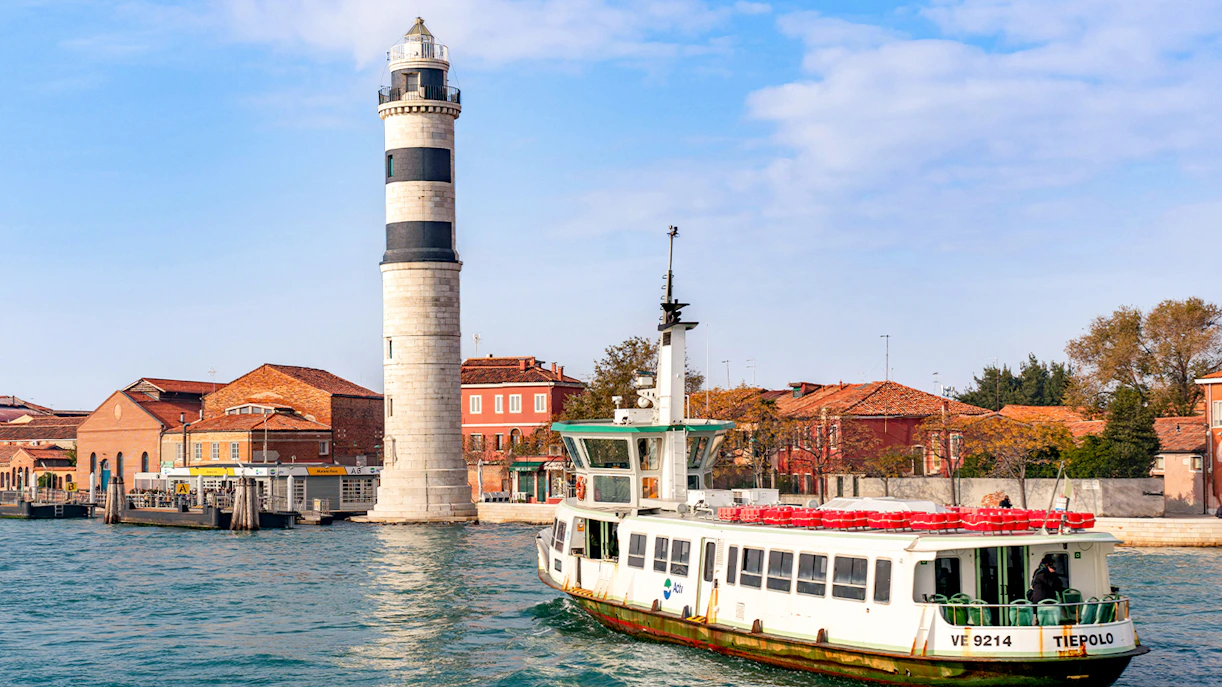 Vaporetto sailing near Murano Island lighthouse, Venice.