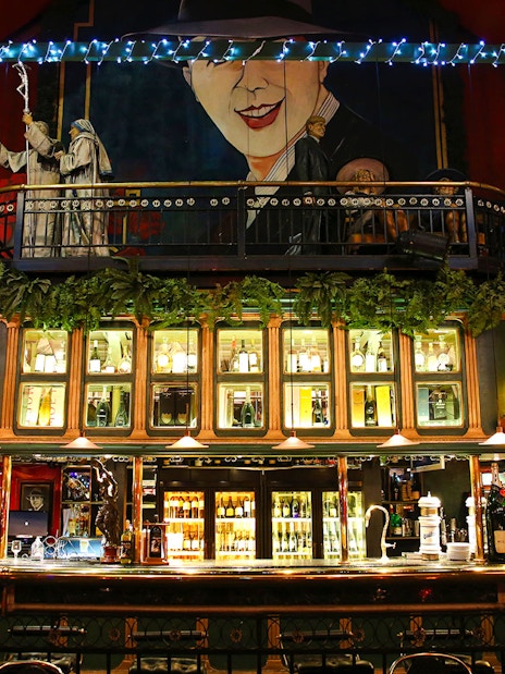 Bar area at Señor Tango Show with illuminated shelves and decorative elements.