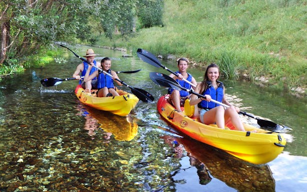 Kayakers paddling in clear water near Podstrana, Adriatic Sea tour.