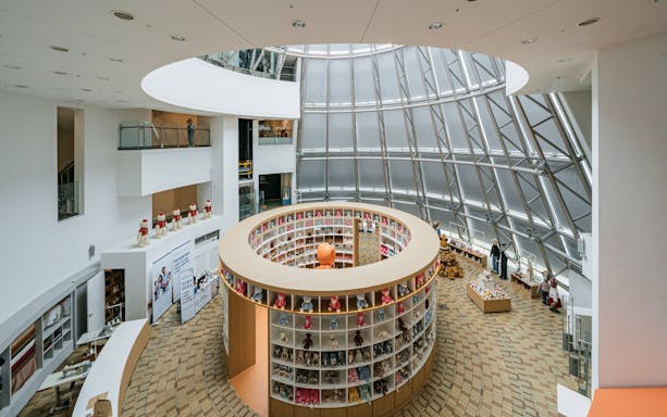 Teddy Bear Museum interior with circular display of teddy bears and visitors exploring exhibits.