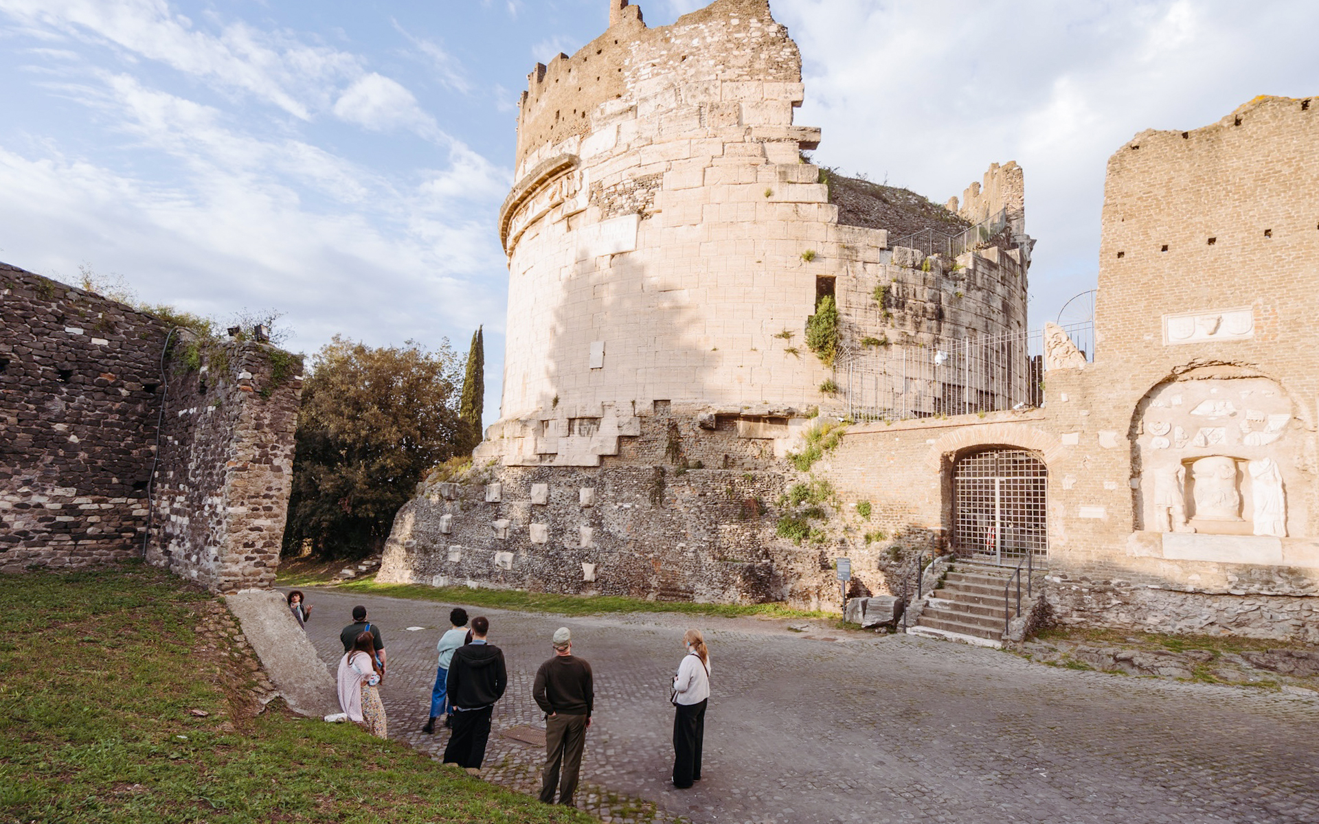 Tour group exploring ancient ruins on the Appian Way in Rome.