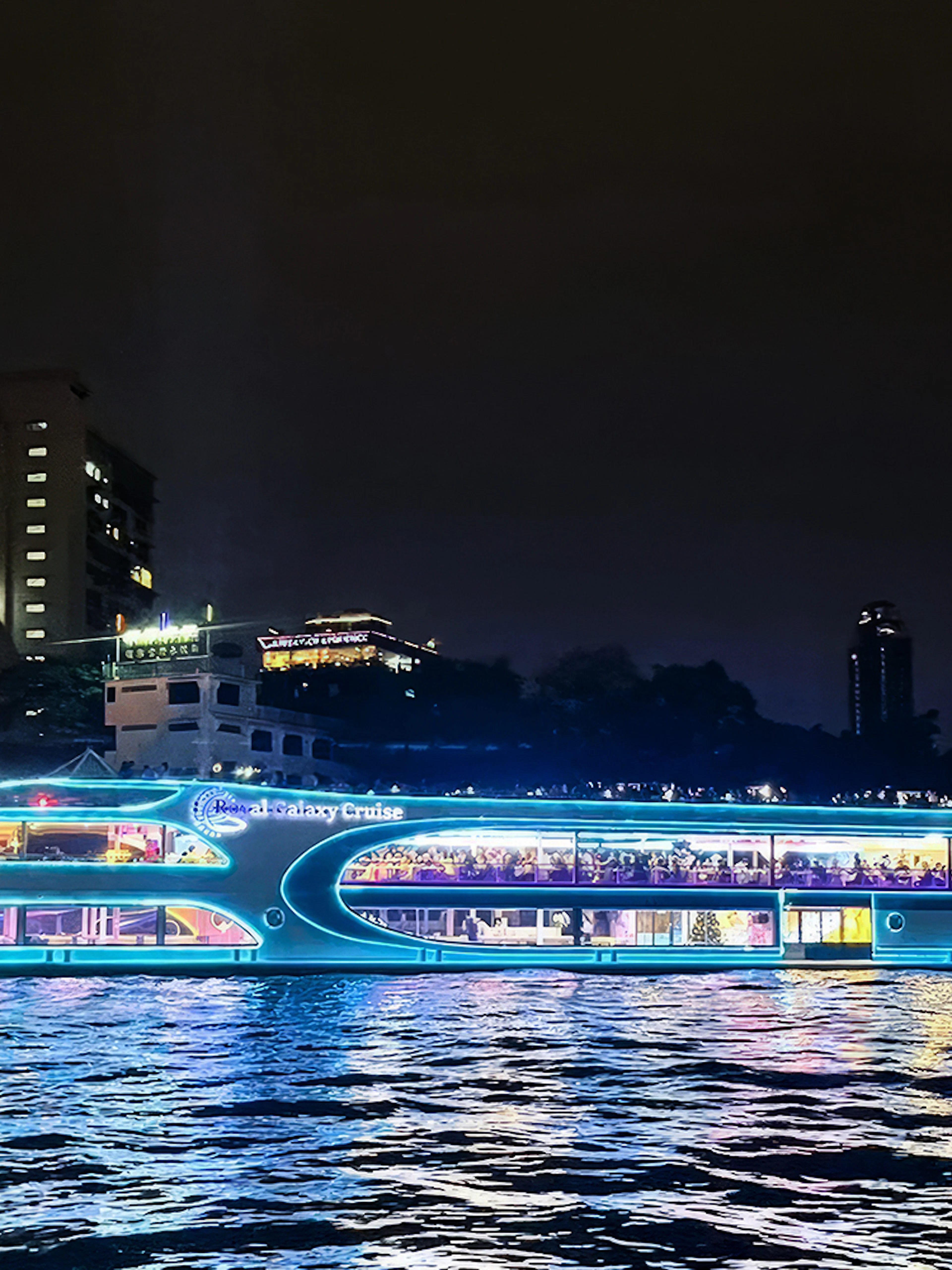 Royal Galaxy cruise ship illuminated on the Chao Phraya River at night, Bangkok.