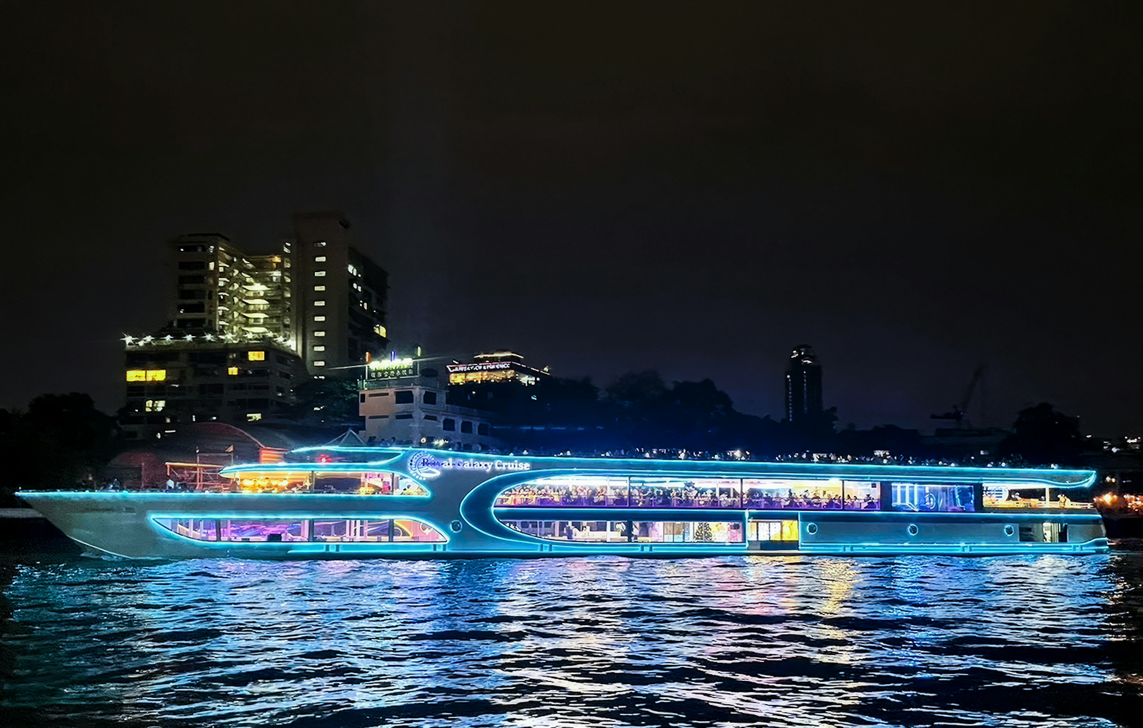 Royal Galaxy cruise ship illuminated on the Chao Phraya River at night, Bangkok.