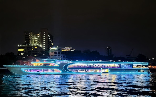 Royal Galaxy cruise ship illuminated on the Chao Phraya River at night, Bangkok.