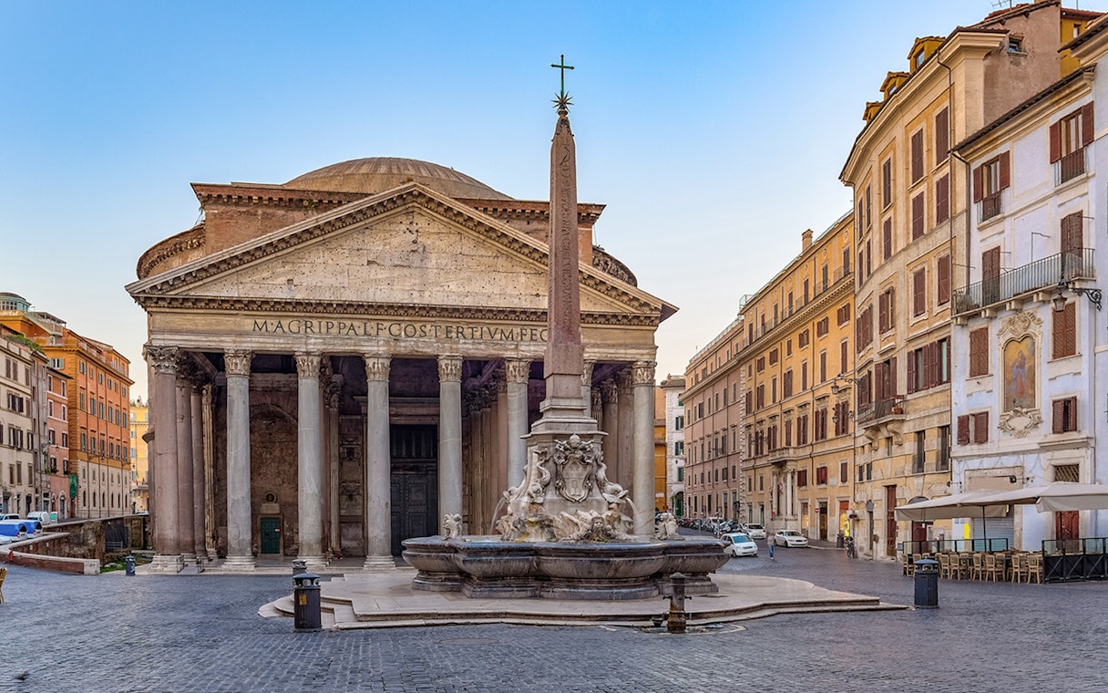 Pantheon in Rome with tourists exploring the ancient Roman temple and nearby fountain.
