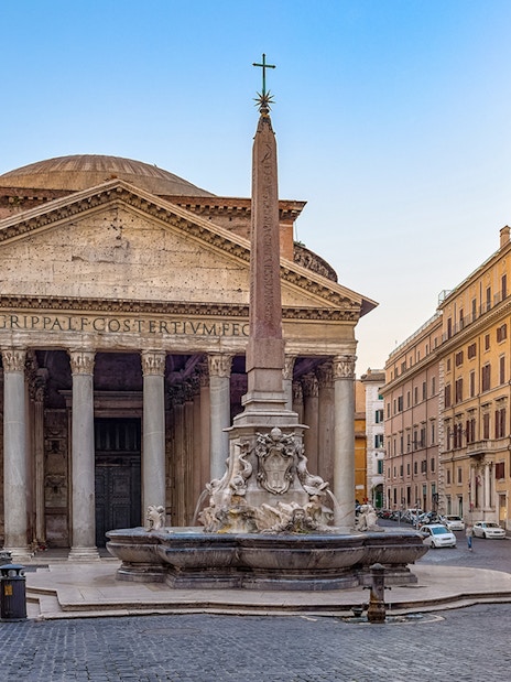 Pantheon in Rome with tourists exploring the ancient Roman temple and nearby fountain.