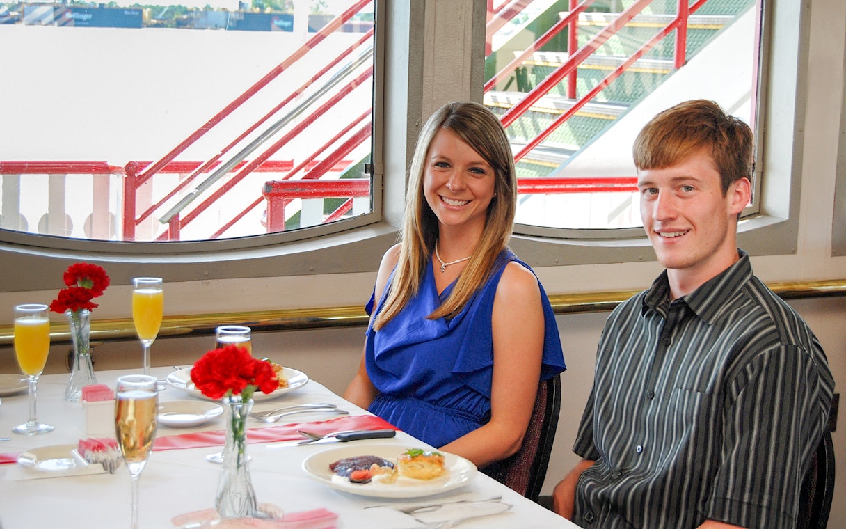 Guests enjoying brunch on the Steamboat Natchez with river view.