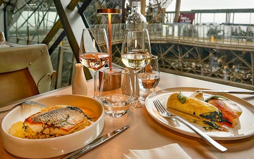 Dinner setting with fish and wine on the first floor of the Eiffel Tower, Paris.