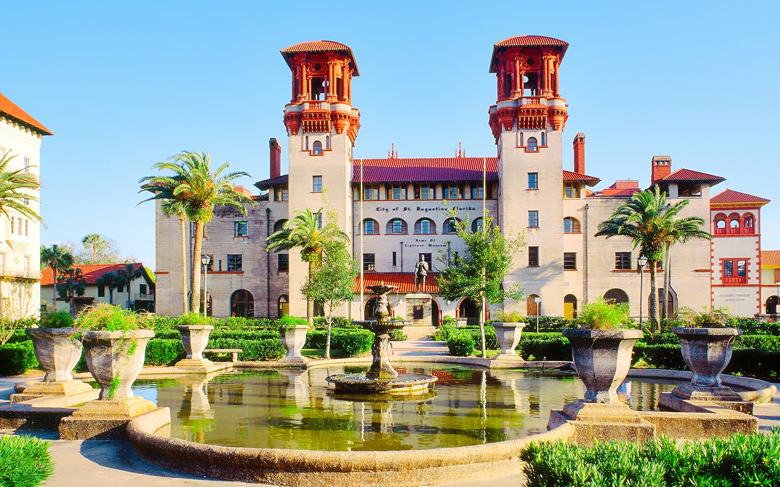 Lightner Museum in St. Augustine with fountain and palm trees in the foreground.