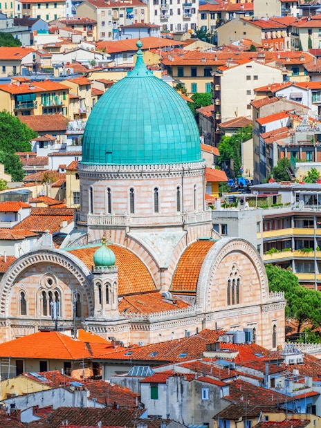 Florence Synagogue with green dome surrounded by cityscape, Italy.
