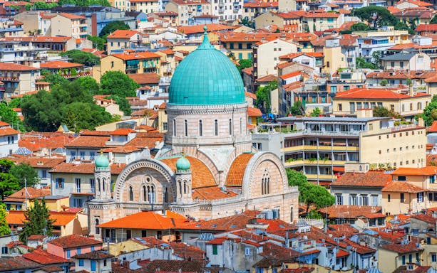 Florence Synagogue with green dome surrounded by cityscape, Italy.