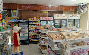 Local market in Santo Domingo with snacks and traditional sweets on display, part of the food walking tour.