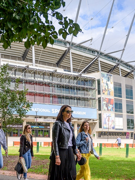 People walking outside Melbourne Cricket Ground on a guided sports tour.