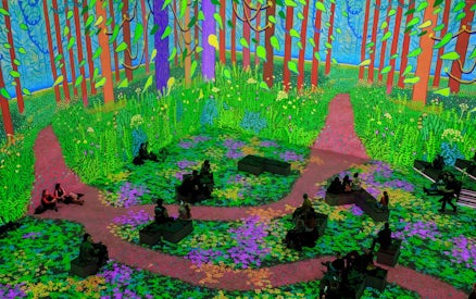 Immersive digital forest scene from David Hockney: Bigger & Closer exhibition with seated visitors.
