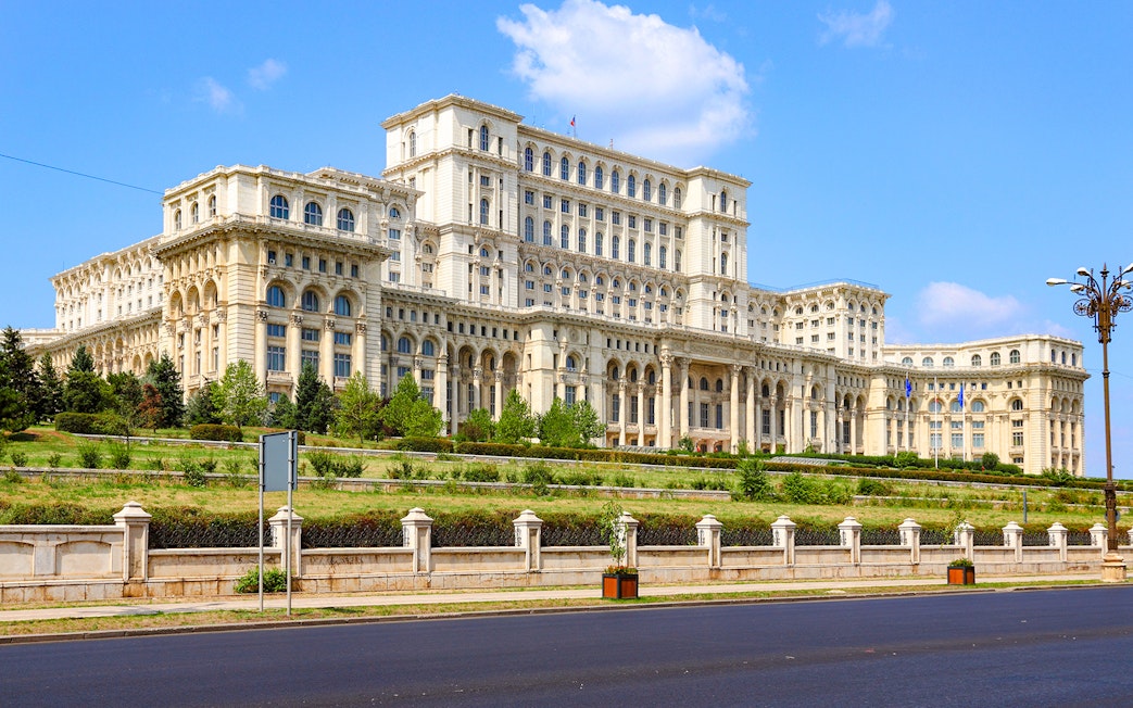 Bucharest Palace of the Parliament exterior with clear blue sky.