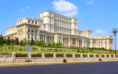 Bucharest Palace of the Parliament exterior with clear blue sky.